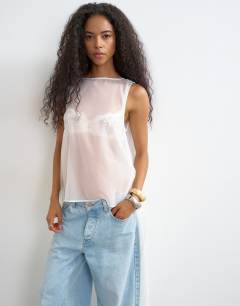 Model wearing Sheer organza drape tunic top in white