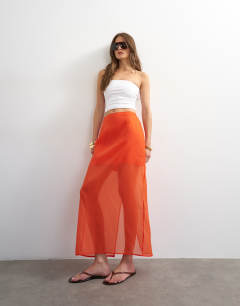Model wearing Sheer organza maxi skirt in fiery orange