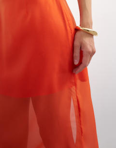 Model wearing Sheer organza maxi skirt in fiery orange