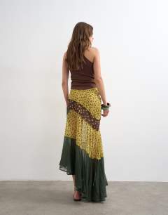 Model wearing Sheer panelled asymmetrical maxi skirt in green and brown spot
