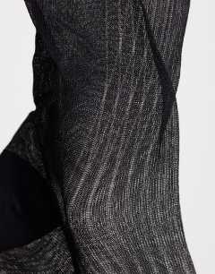 Model wearing Sheer ribbed sock in black