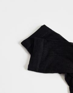 Model wearing Sheer ribbed sock in black