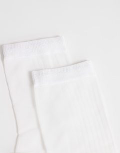 Model wearing Sheer ribbed sock in white