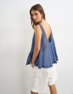 Model wearing Sheer sleeveless pintuck cami in indigo