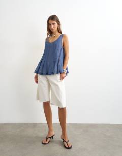 Model wearing Sheer sleeveless pintuck cami in indigo