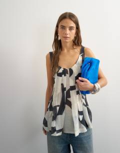 Model wearing Sheer sleeveless pintuck cami in mono print