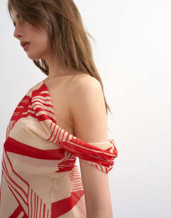 Model wearing Sheer stripe print off shoulder top co-ord in red