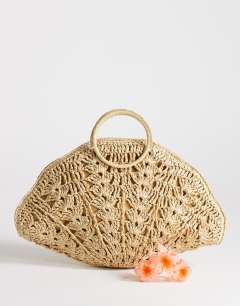 Model wearing Shelly medium weave shell small grab bag in natural