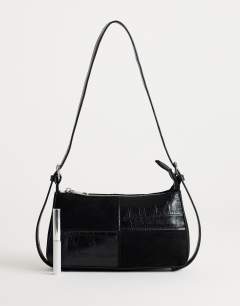 Model wearing Sherry small patchwork shoulder bag in black