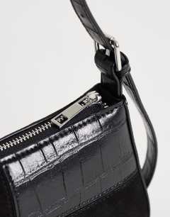 Model wearing Sherry small patchwork shoulder bag in black