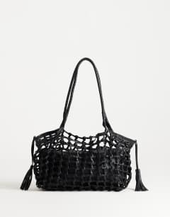 Model wearing Shia medium woven shoulder bag in black