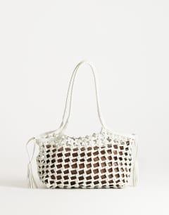 Model wearing Shia medium woven shoulder bag in off white