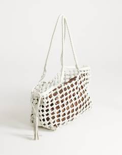 Model wearing Shia medium woven shoulder bag in off white