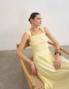 Model wearing Shirred bust dropped waist midi poplin dress in buttermilk