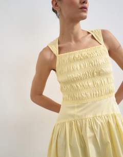 Model wearing Shirred bust dropped waist midi poplin dress in buttermilk