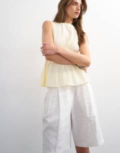 Model wearing Shirred detail sleeveless top in sand