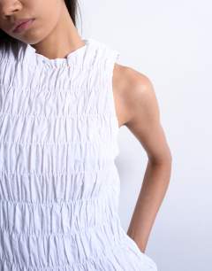 Model wearing Shirred tank top in white