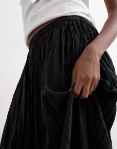 Model wearing Shirred waist crinkle full circle skirt in black