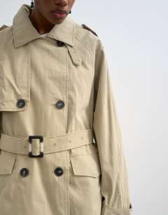 Model wearing Short belted mac in stone