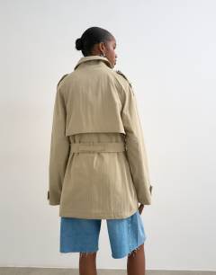 Model wearing Short belted mac in stone