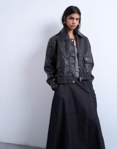 Model wearing Short bubble faux leather bomber jacket in black