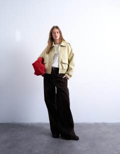 Model wearing Short bubble faux leather bomber jacket in buttermilk