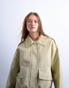 Model wearing Short bubble faux leather bomber jacket in buttermilk