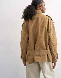 Model wearing Short cotton belted bomber jacket in tan