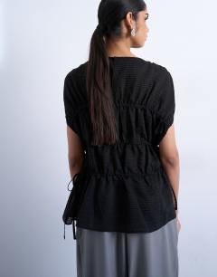 Model wearing Short sleeve channelled tie side top in black