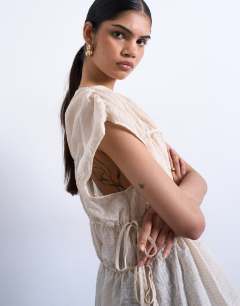 Model wearing Short sleeve channelled tie side top in ecru