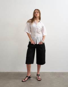 Model wearing Short sleeve fitted shirt with gathered waist in white