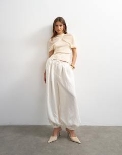 Model wearing Short sleeve sheer gathered top in ivory