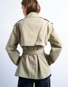 Model wearing Short trench coat in stone
