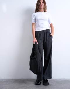 Model wearing Sia ruched nylon shoulder bag in black