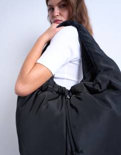 Model wearing Sia ruched nylon shoulder bag in black