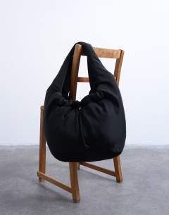Model wearing Sia ruched nylon shoulder bag in black