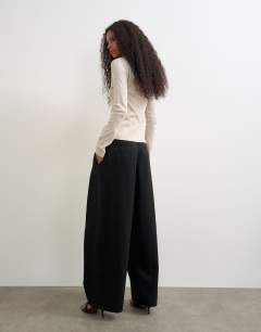 Model wearing Side buckle wide leg mid rise jean in clean black