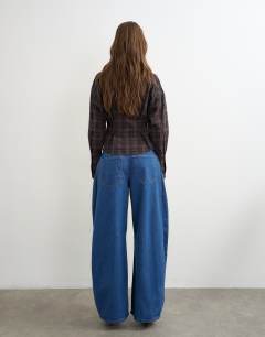 Model wearing Side pleat cocoon jean in rich blue