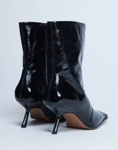 Model wearing Sienna Premium leather square toe mid heel boot in black