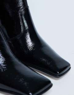 Model wearing Sienna Premium leather square toe mid heel boot in black