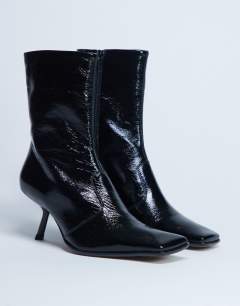 Model wearing Sienna Premium leather square toe mid heel boot in black