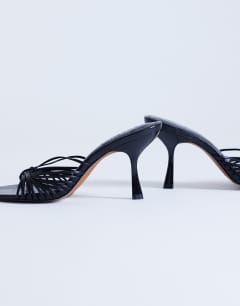Model wearing Simba strappy mule high sandal in black