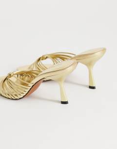 Model wearing Simba strappy mule high sandal in gold