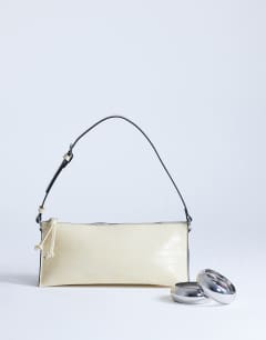 Model wearing Simone shoulder bag in off white
