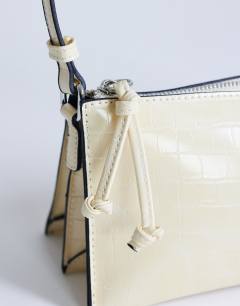 Model wearing Simone shoulder bag in off white