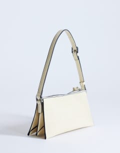 Model wearing Simone shoulder bag in off white