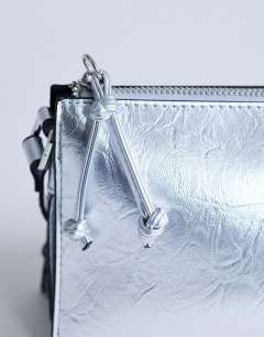 Model wearing Simone shoulder bag in silver