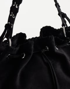 Model wearing Simone suedette pocket detail bucket shoulder bag in black