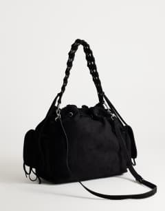 Model wearing Simone suedette pocket detail bucket shoulder bag in black