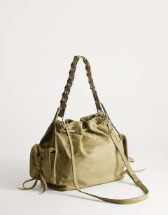 Model wearing Simone suedette pocket detail bucket shoulder bag in khaki